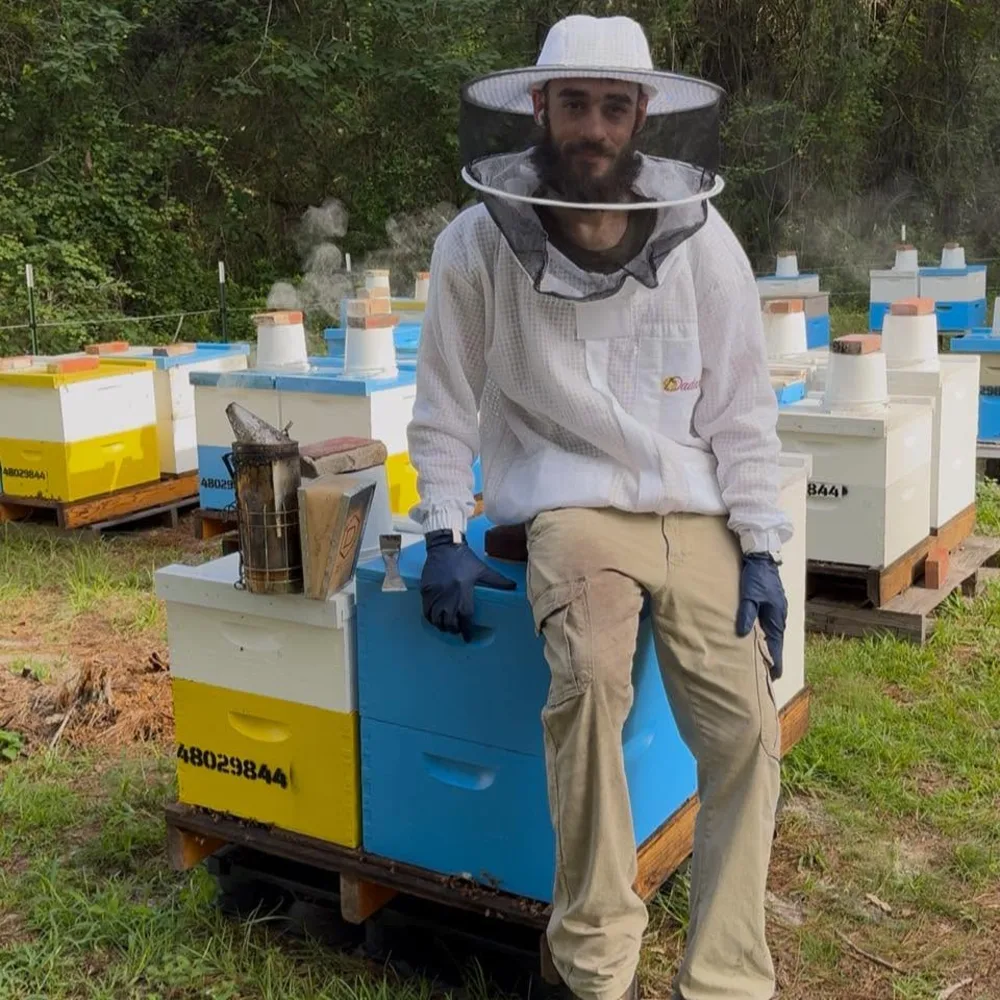 The Synergy Farm beekeeper at the hives